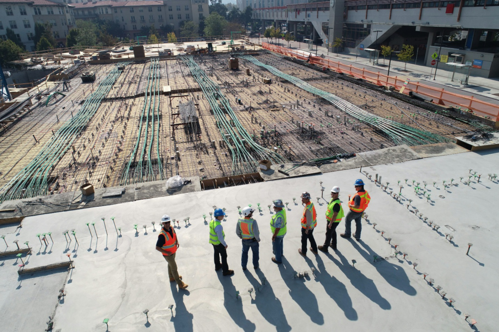 A team of construction workers standing and talking.