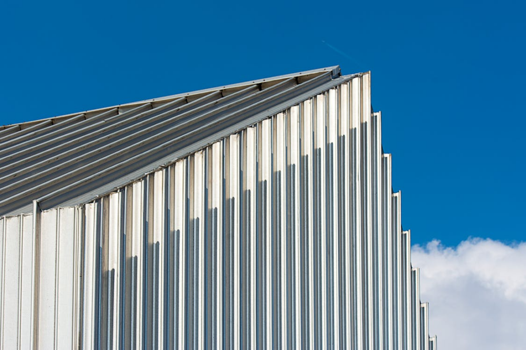 Corrugated metal roof panels with clean vertical lines under a bright blue sky in Spring Branch, Texas