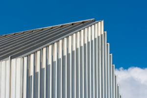Corrugated metal roof panels with clean vertical lines under a bright blue sky in Spring Branch, Texas