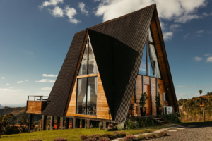 Modern A-frame metal home with wood accents and large glass windows in Spring Branch, Texas