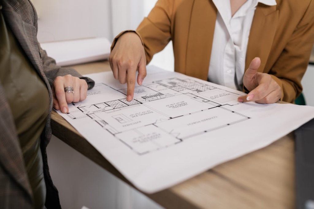 a person reviewing a floor plan layout on a table