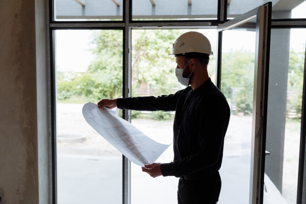 a contractor reviewing building plans at a construction site