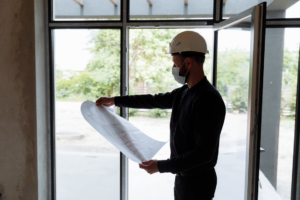 a contractor reviewing building plans at a construction site