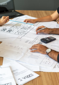 Several people are planning and working on a building around the table.