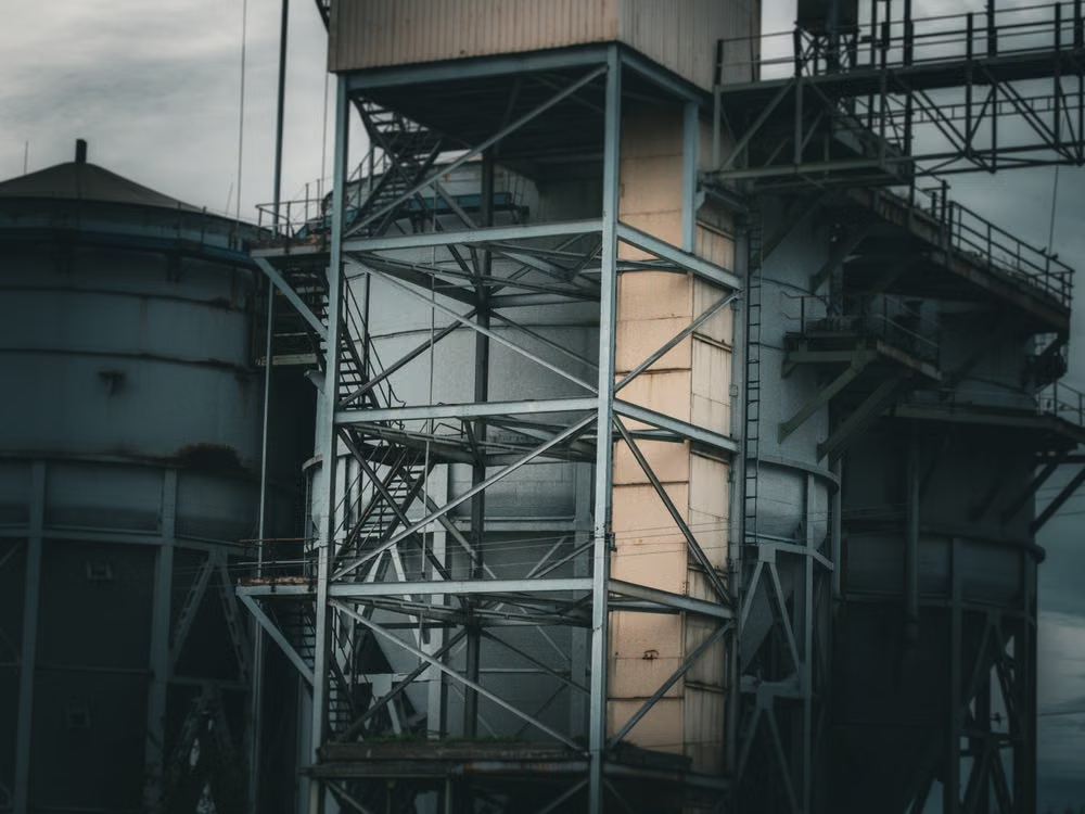 A large metal building with stairs and sections.