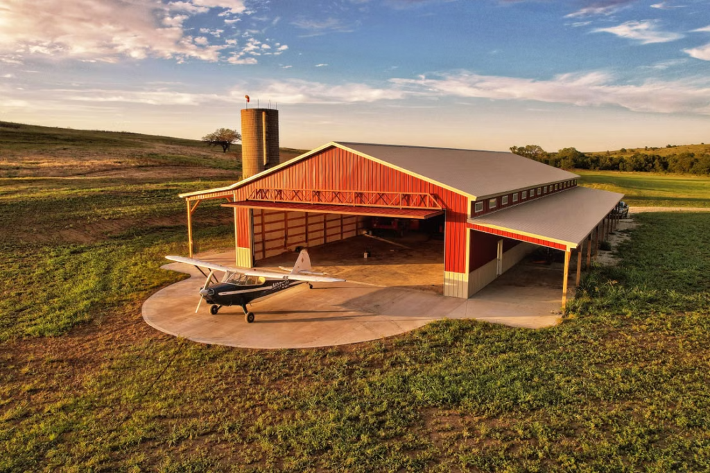 A large barndominium construction with a large farm area.
