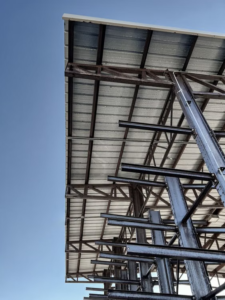A large metal building with a shade.